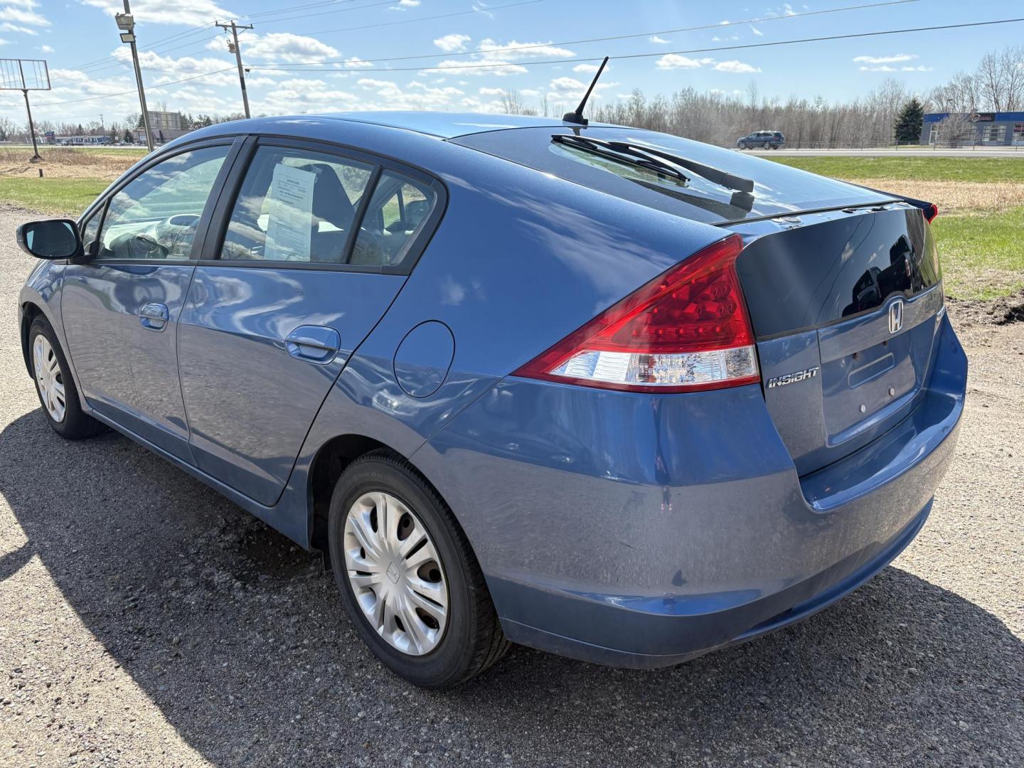2010 Blue Honda Insight LX (JHMZE2H58AS) with an 1.3L L4 SOHC 8V HYBRID engine, Continuously Variable Transmisson transmission, located at 17255 hwy 65 NE, Ham Lake, MN, 55304, 0.000000, 0.000000 - Photo#2